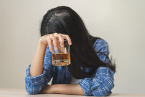 A person struggles with alcohol dependence.