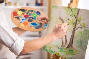 A person participates in art therapy, an experiential therapy for addiction treatment.